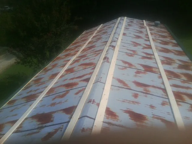 Rusted metal roof panels with new wood purlins before replacement — Storm Damage Roof Repair in Sparkill by Roofing Brothers
