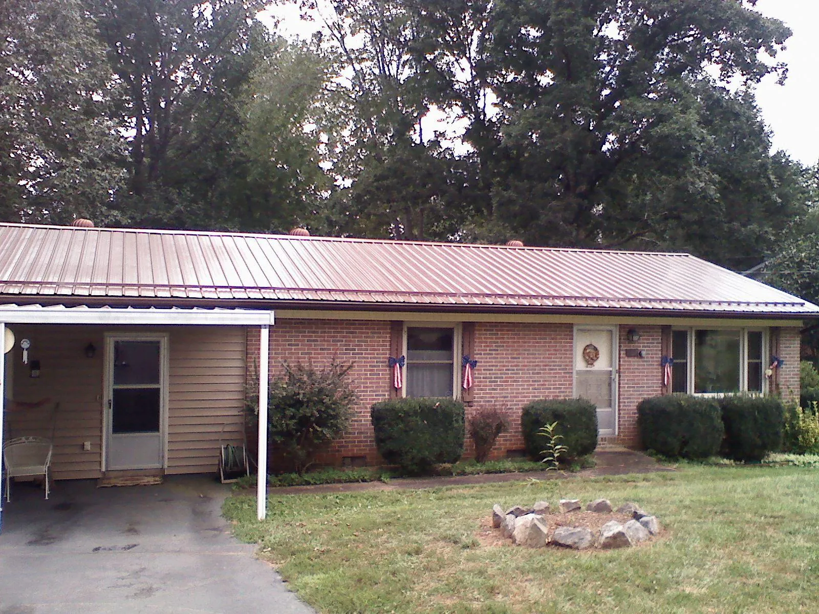 Bronze metal roof and carport on a brick ranch home — Roof Repair work by our crew in Sparkill